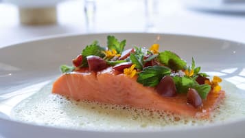 A plate of food with salmon and garnishes.