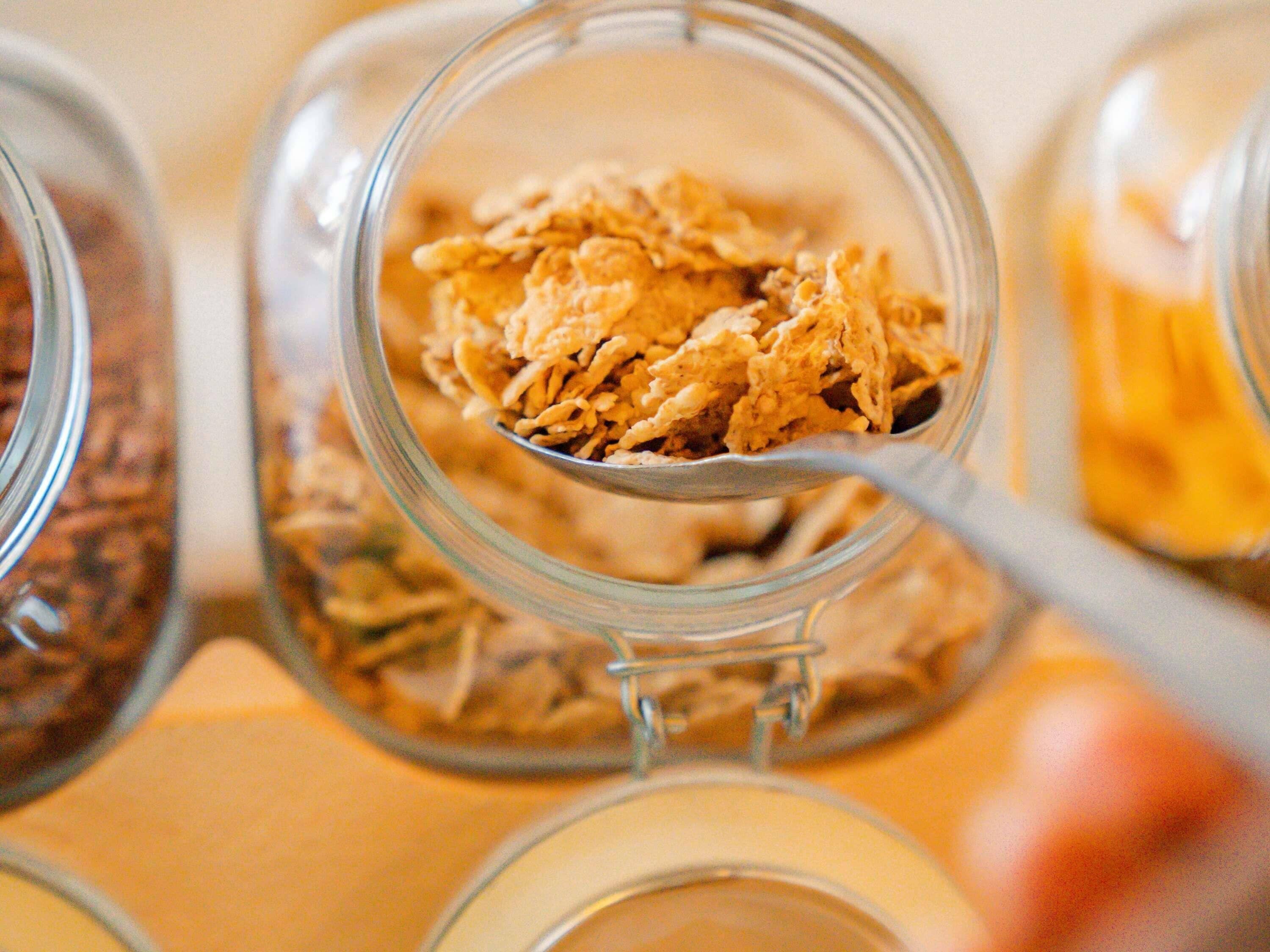 A close-up of a glass jar filled with granola.