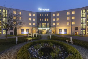 TH Hotels München Airport offers a contemporary entrance with a garden and water feature.