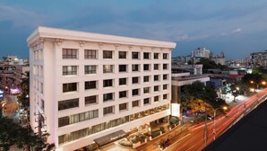 A multi-story hotel with a modern facade, large windows, and a well-lit entrance area. - The Avenue Regent (Kanayannur)