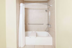 Enjoy a refreshing shower or soak in the separate bathtub, complete with a curved showerhead and handheld shower attachment.
