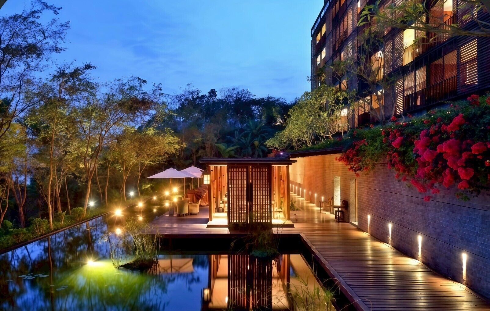 A modern building with a wooden deck and a water feature in front.