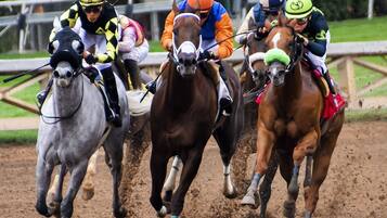 A horse race with jockeys on horses.