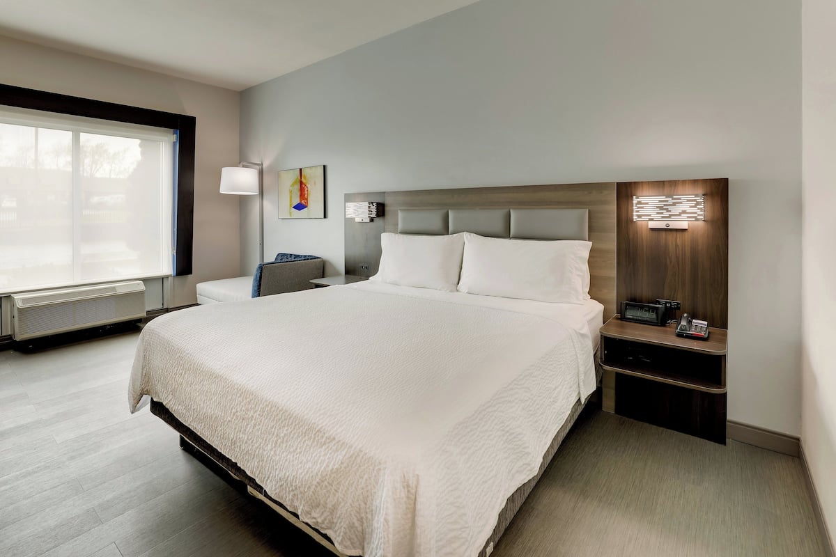 Premium bedding, desk, laptop workspace, blackout drapes