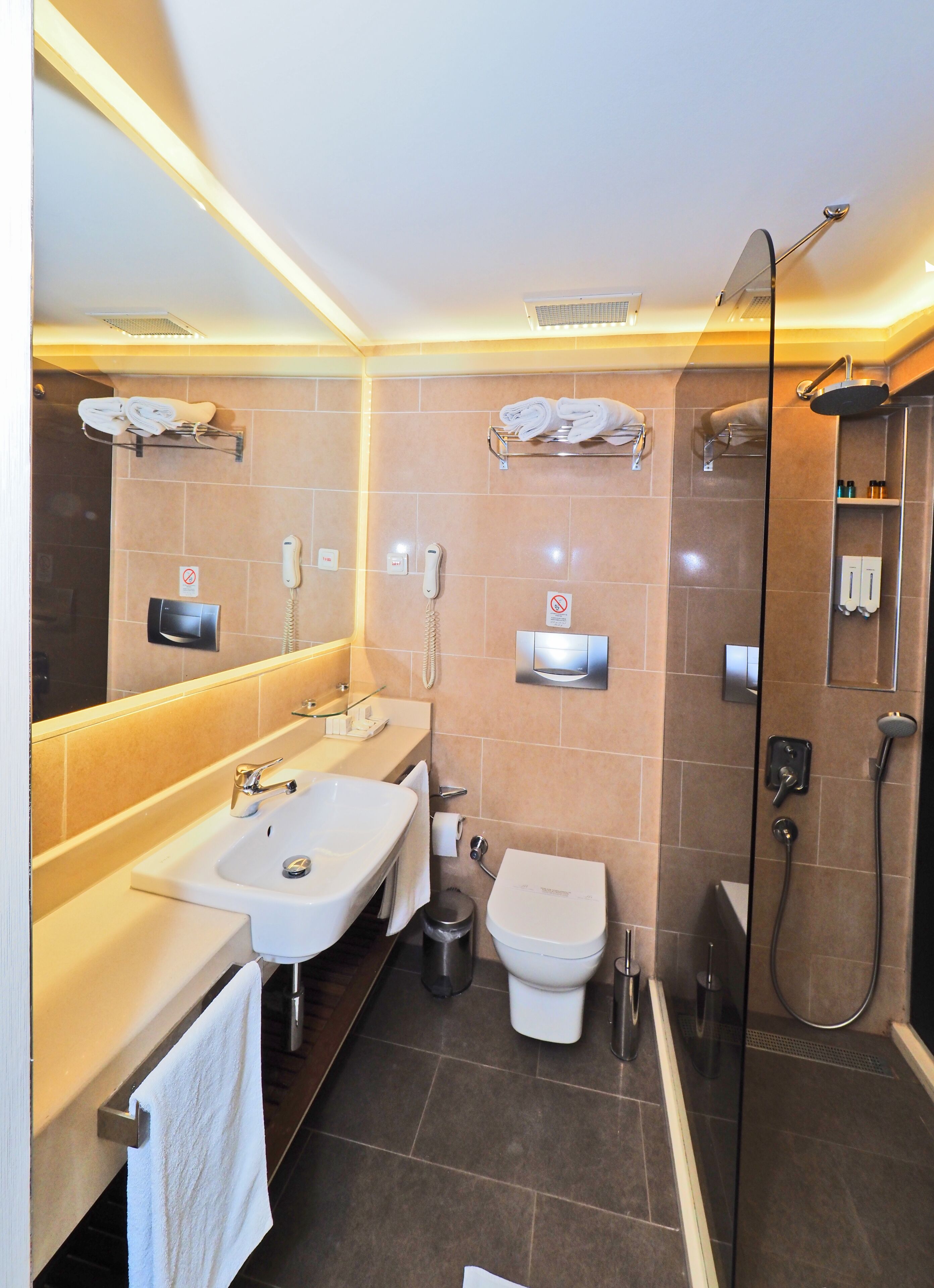 shower, hair dryer, slippers, towels