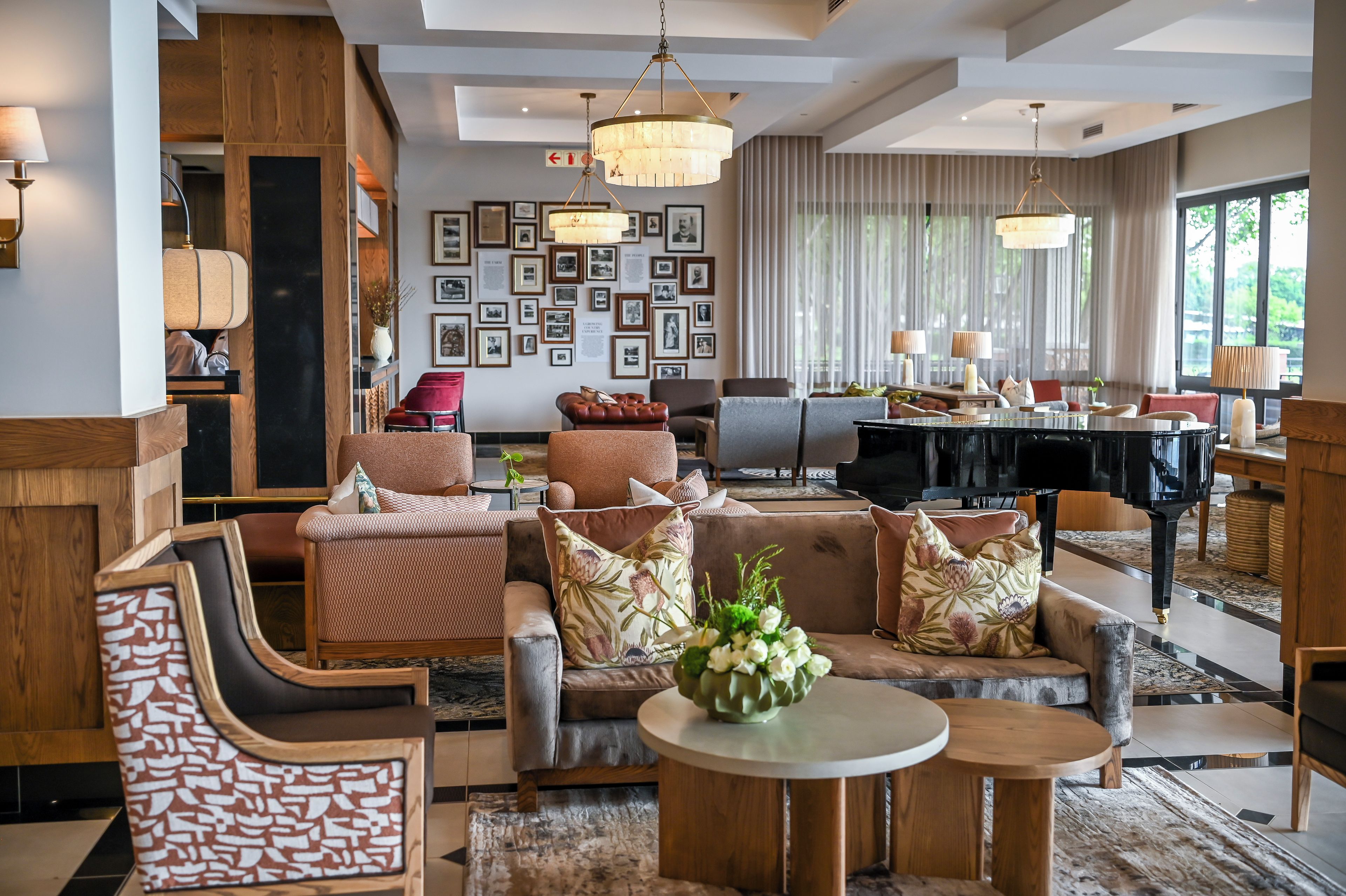 A modern living room with a fireplace, comfortable seating, and a dining area.