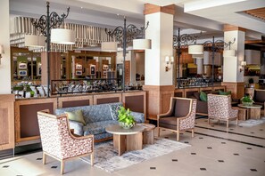 A hotel lobby with a seating area, a reception desk, and a bar. - Irene Country Hotel (Irene, Centurion)