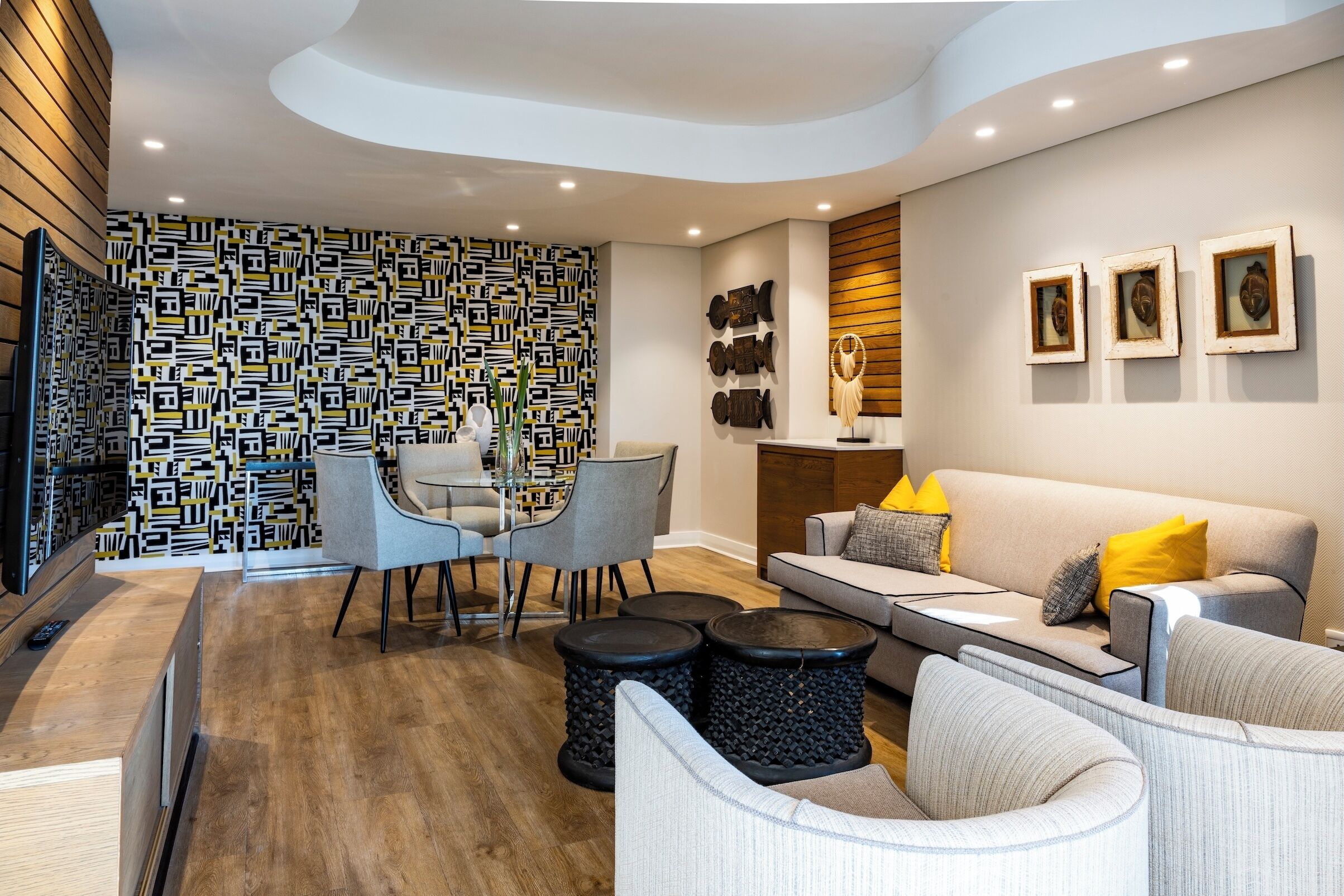 A modern living room with a patterned wall, a sofa set, and a coffee table.