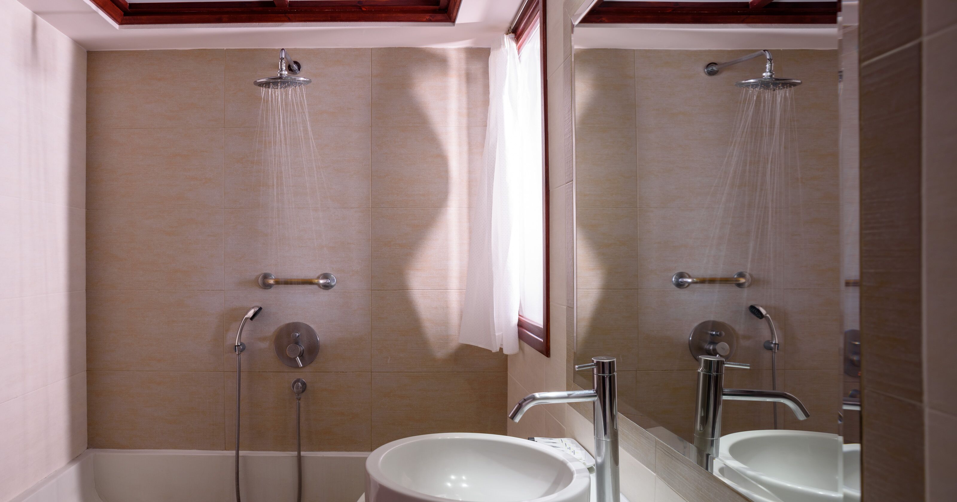 A bathroom with a bathtub, a shower, and a sink.
