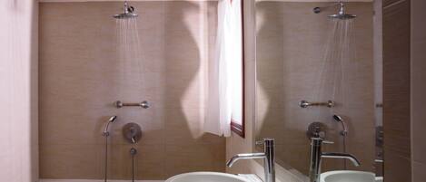 A bathroom with a bathtub, a shower, and a sink.