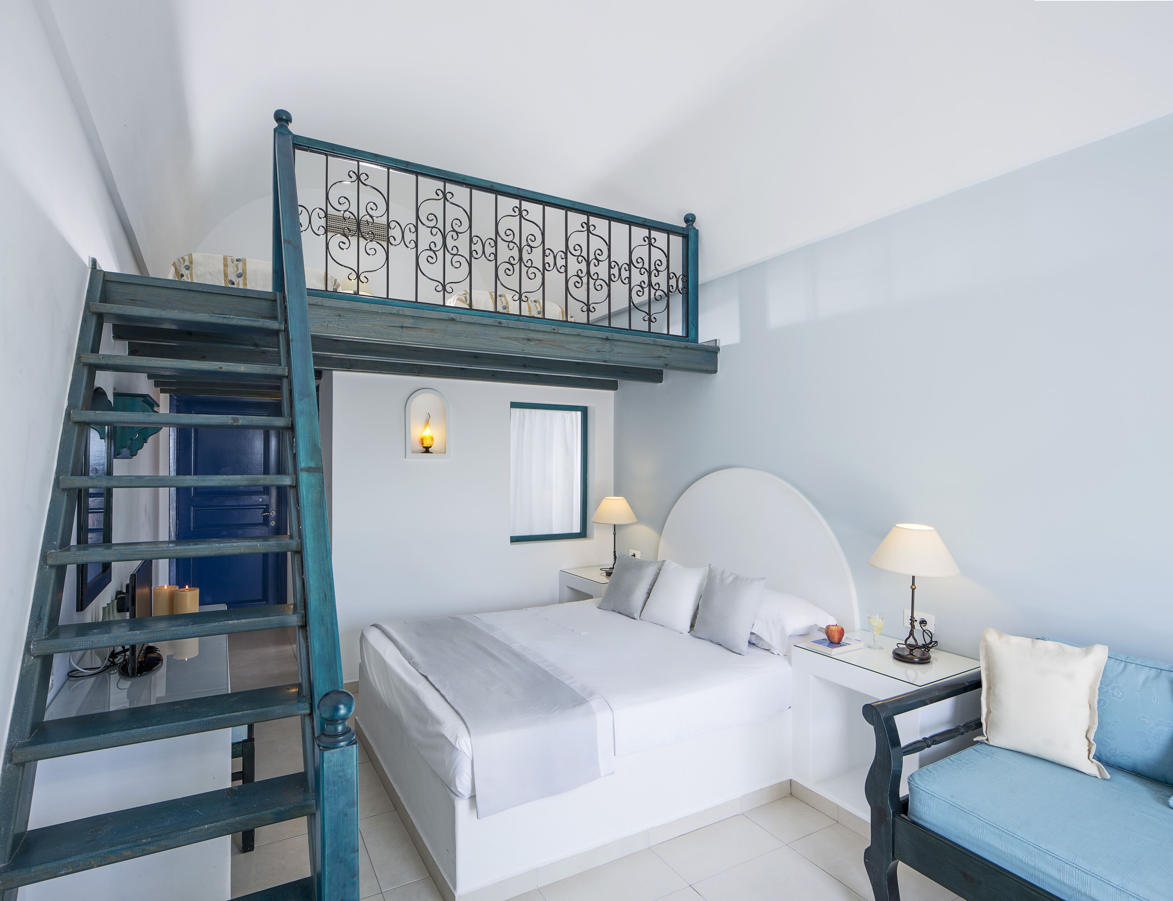 Un dormitorio con una cama litera, un escritorio, dos lámparas de noche y una ventana pequeña.
