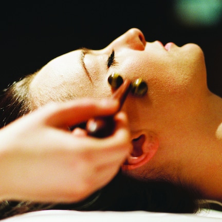 A close-up of a person receiving a facial treatment.