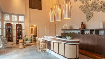 A modern interior with a bar area, seating, and decorative wall art.