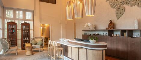 A modern interior with a bar area, seating, and decorative wall art.