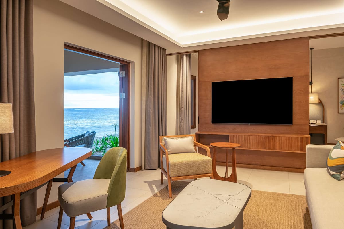 Junior Suite, 1 King Bed, Beachfront | Living area | 42-inch TV with satellite channels