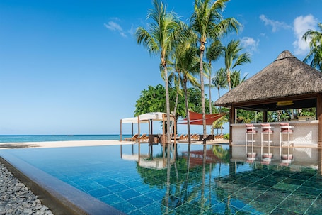 2 piscinas al aire libre, sombrillas, sillones reclinables de piscina. Hilton Mauritius Resort & Spa