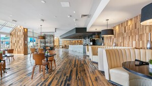 A spacious lobby with wooden flooring, seating areas, and a modern design. - Hotel Zoso (Palm Springs)