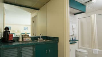 A bathroom with a sink, toilet, and shower.