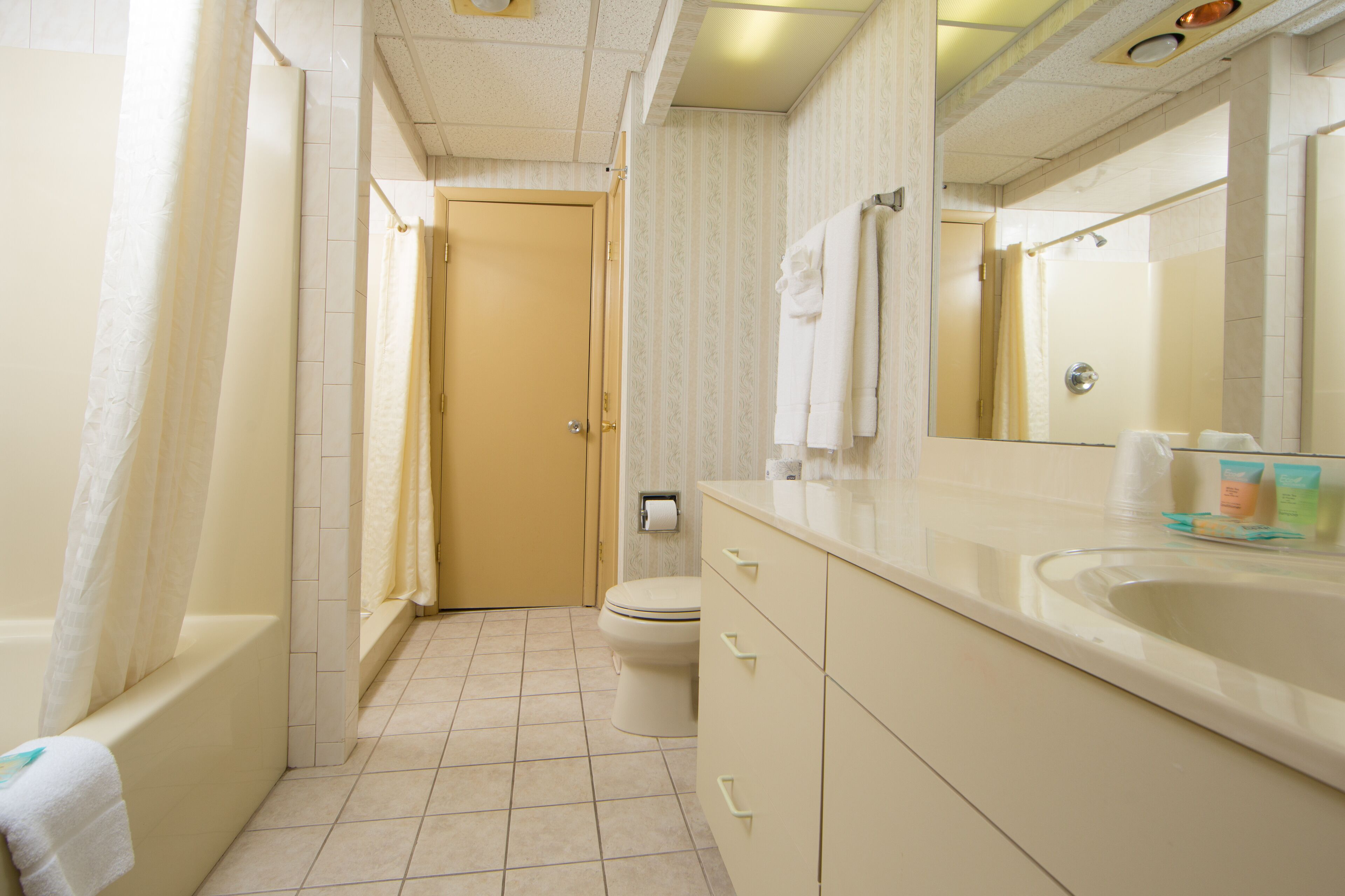 A bathroom with a bathtub, toilet, and sink.