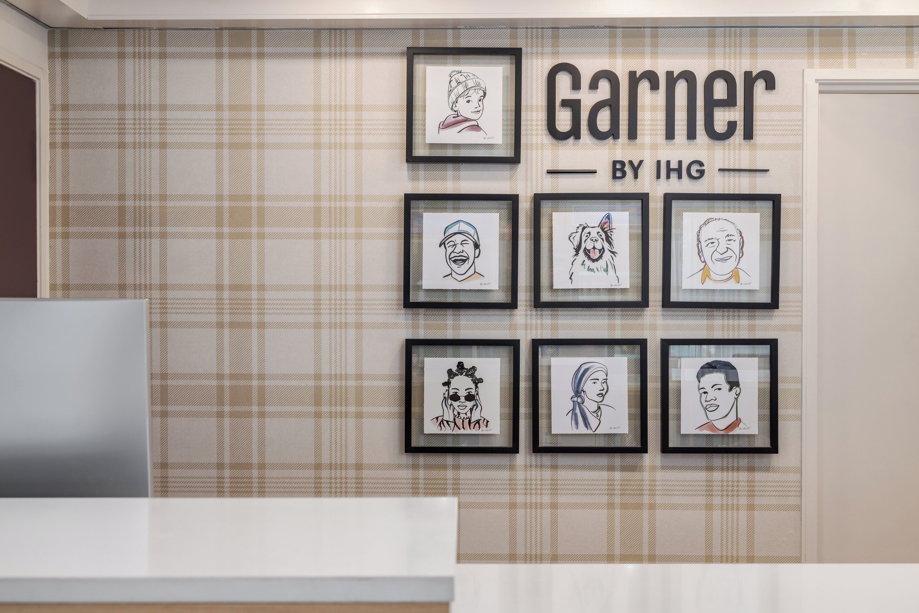 A wall with a plaid pattern and a sign that reads "Garnier BY IHG".