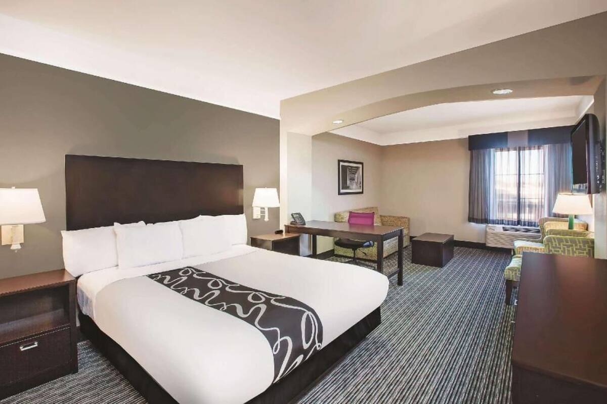 Premium bedding, desk, laptop workspace, blackout drapes