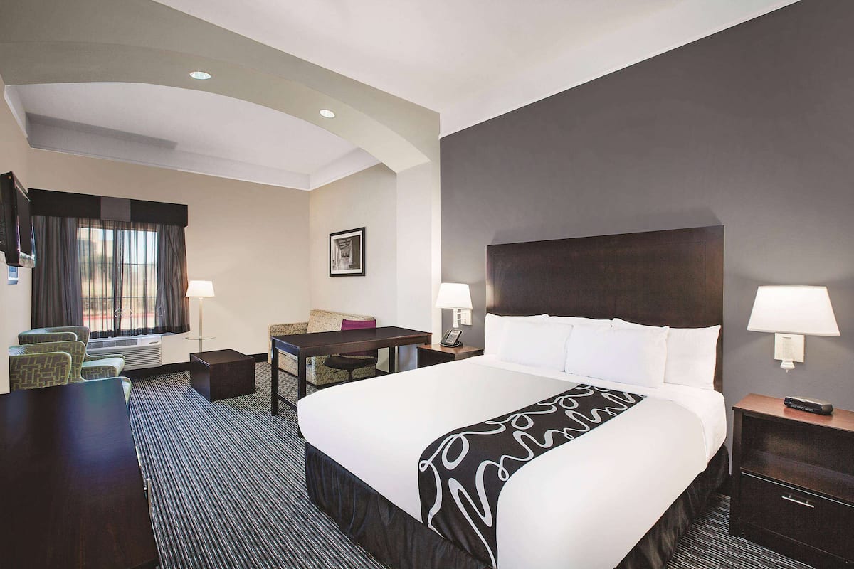 Premium bedding, desk, laptop workspace, blackout drapes