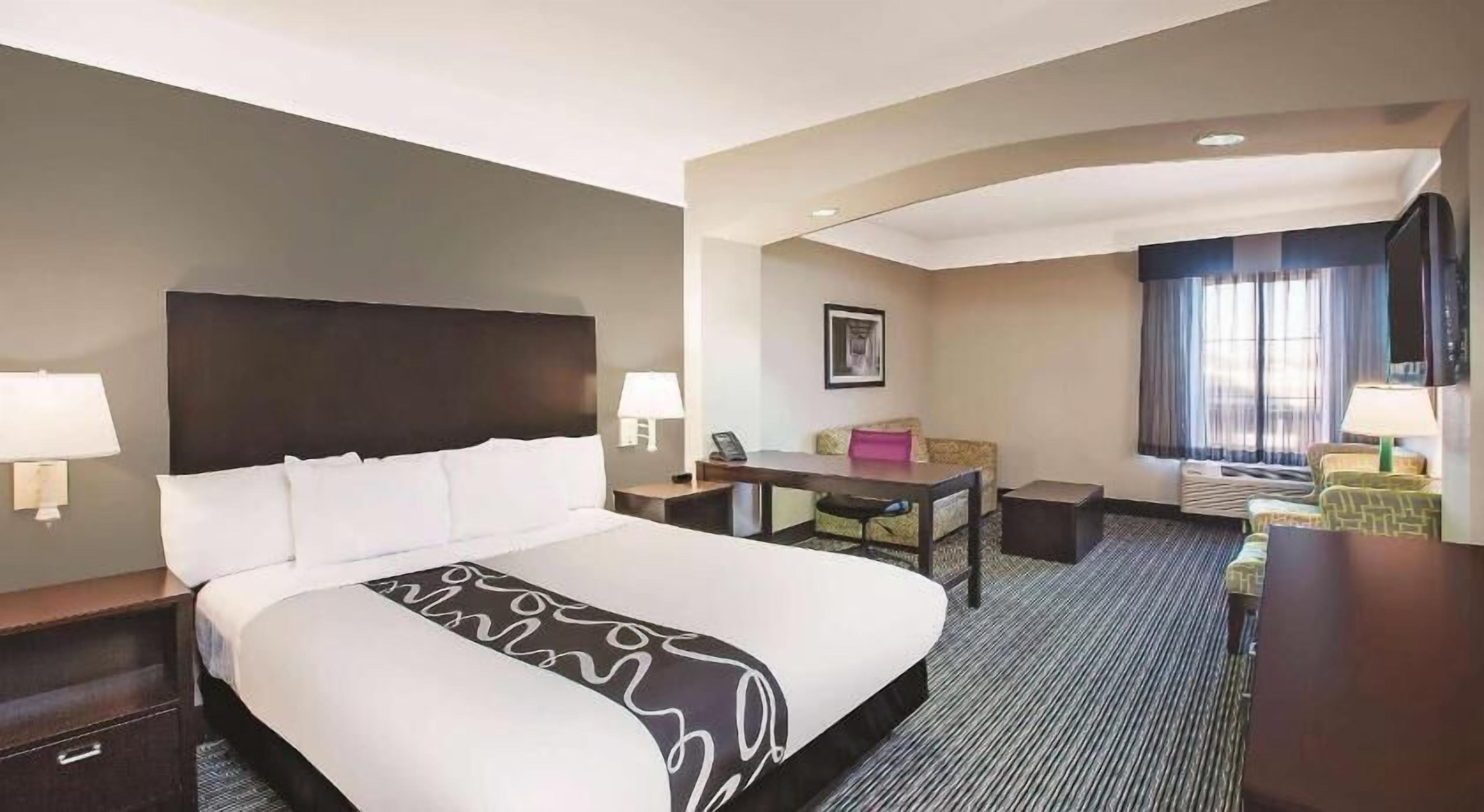 Premium bedding, desk, laptop workspace, blackout drapes
