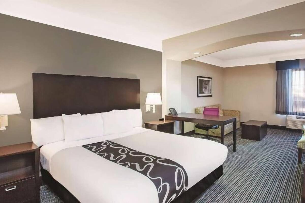 Premium bedding, desk, laptop workspace, blackout drapes