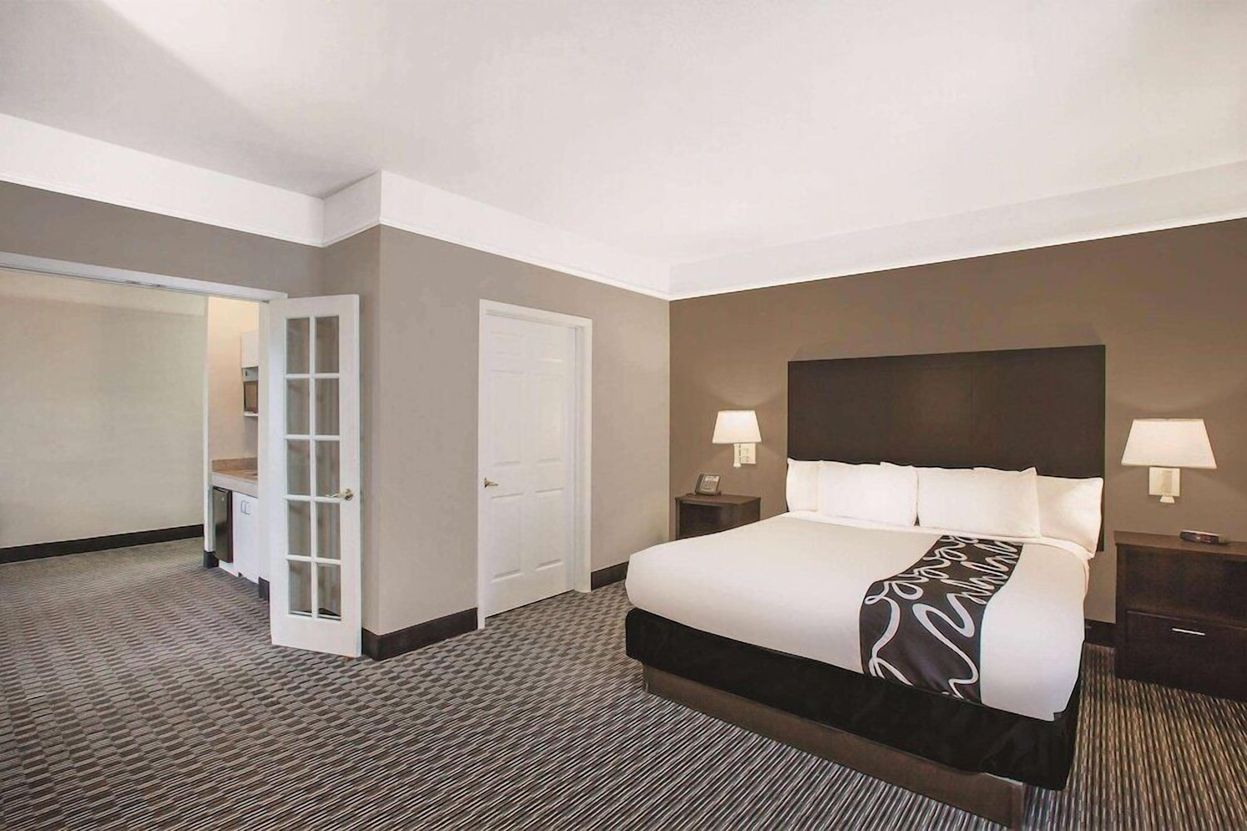 Premium bedding, desk, laptop workspace, blackout drapes