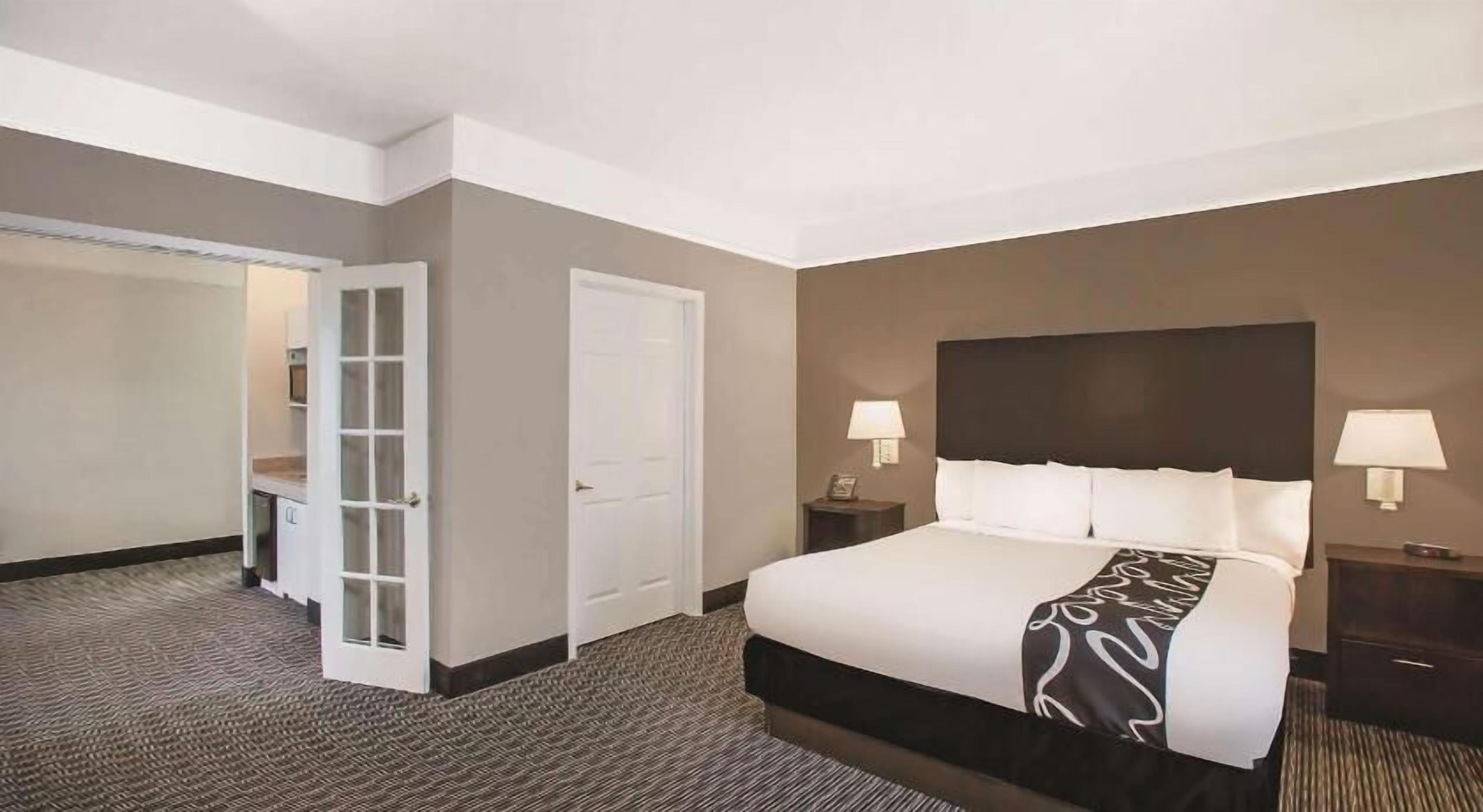 Premium bedding, desk, laptop workspace, blackout drapes