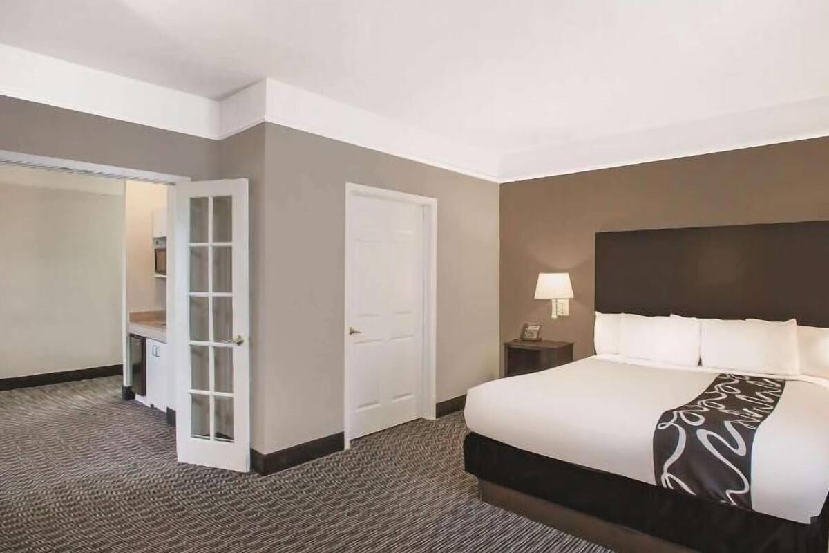 Premium bedding, desk, laptop workspace, blackout drapes