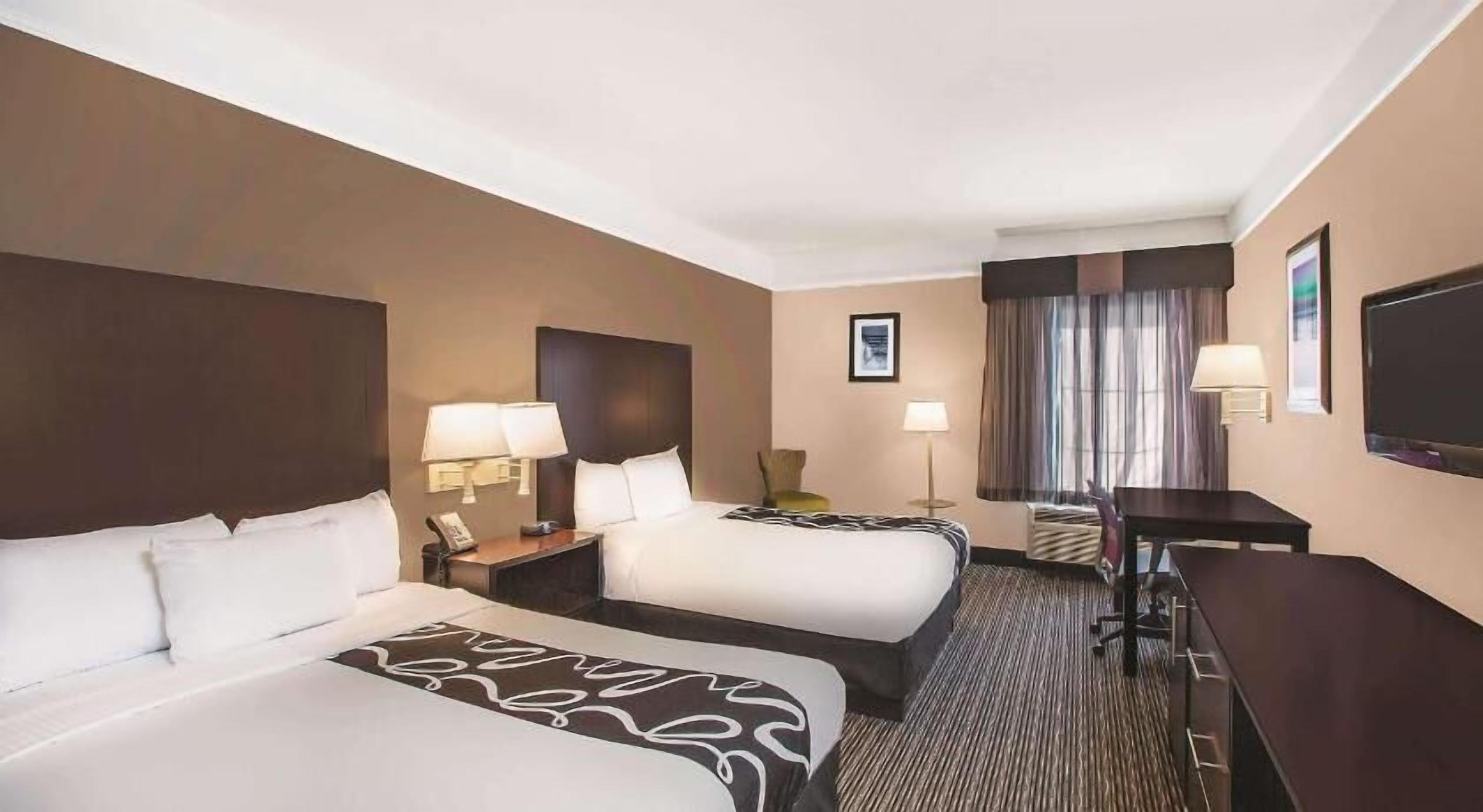 Premium bedding, desk, laptop workspace, blackout drapes