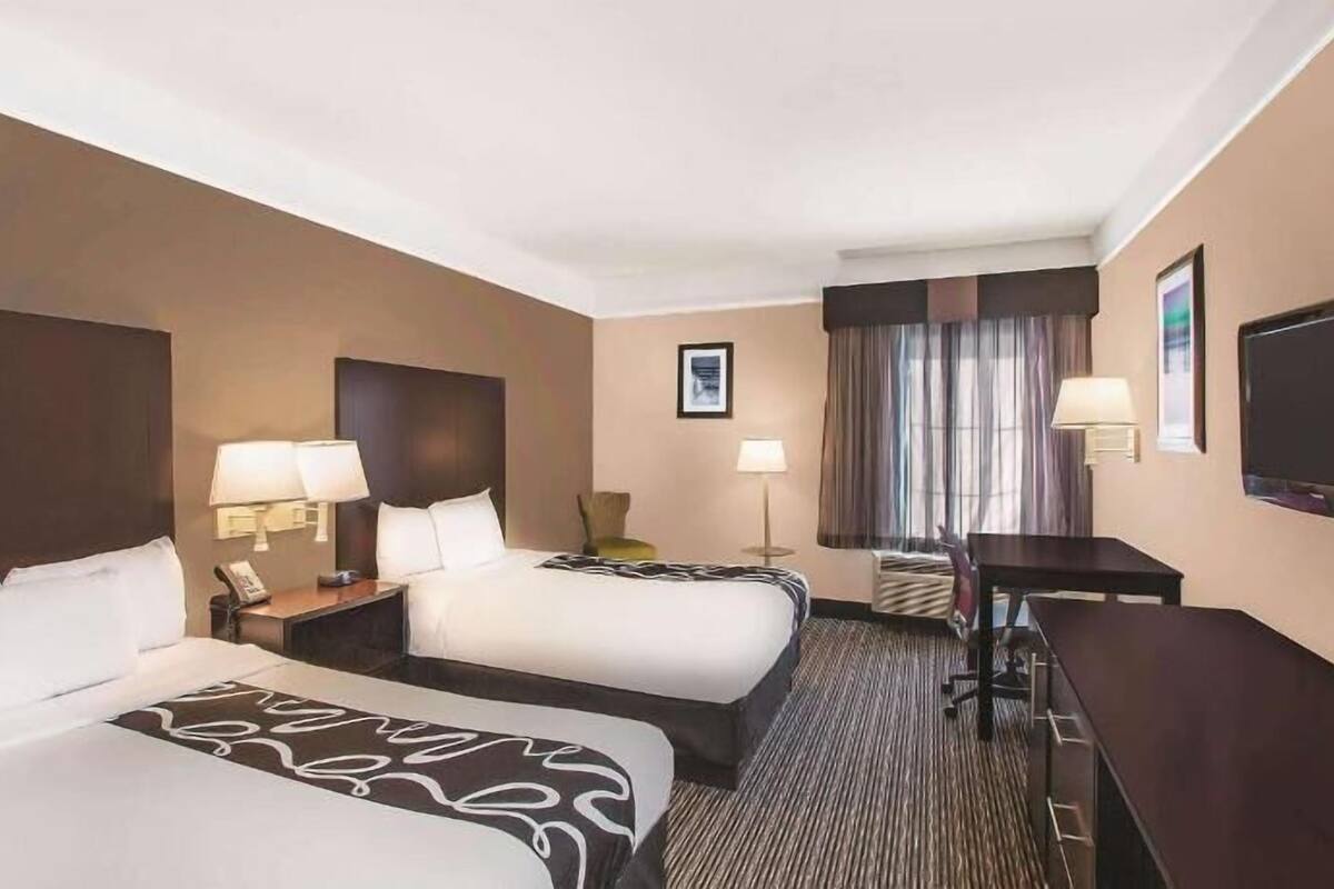 Premium bedding, desk, laptop workspace, blackout drapes