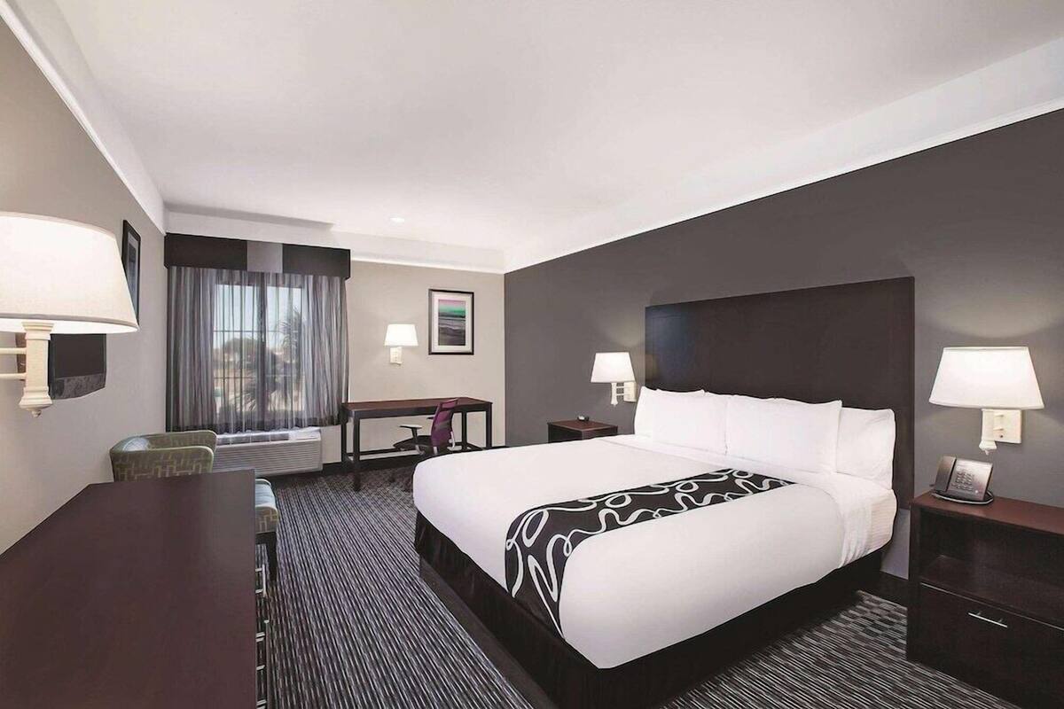 Premium bedding, desk, laptop workspace, blackout drapes