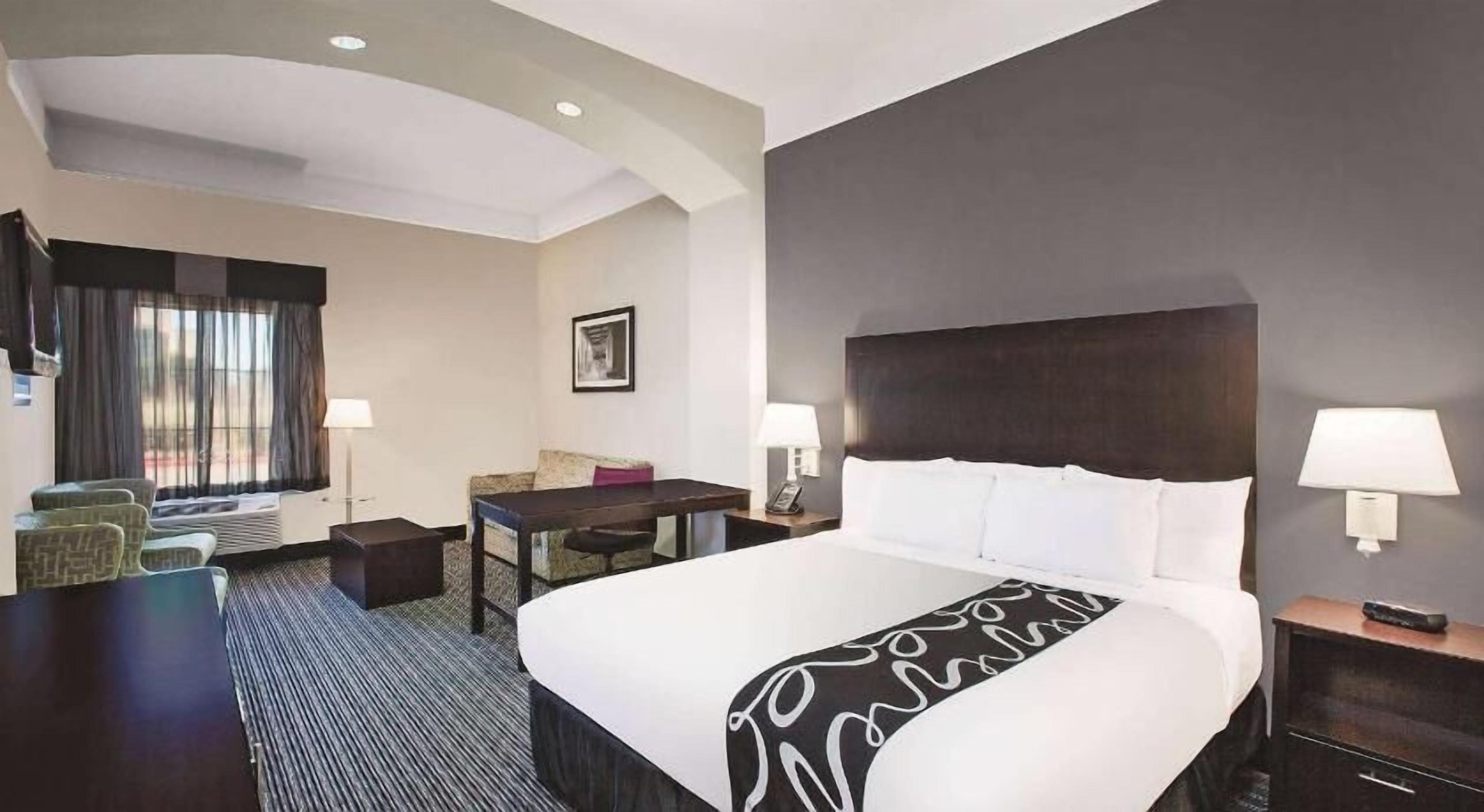 Premium bedding, desk, laptop workspace, blackout drapes