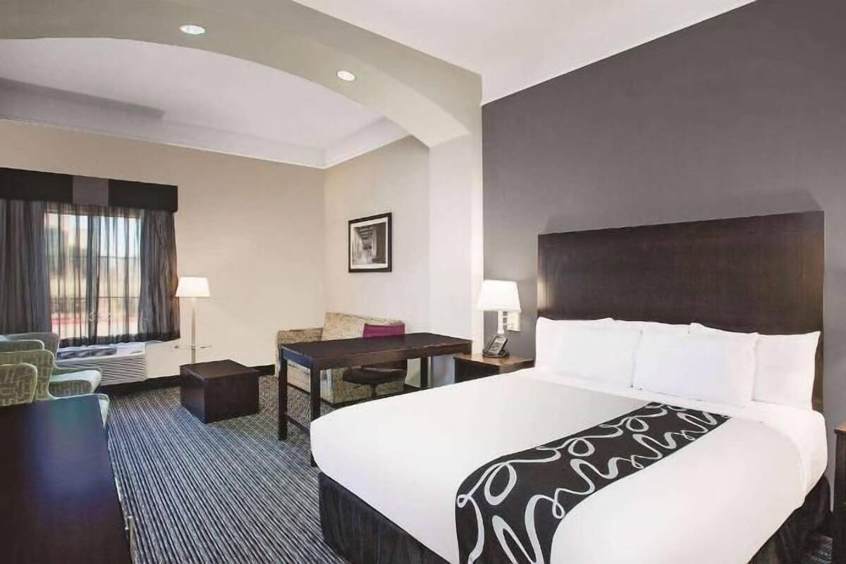 Premium bedding, desk, laptop workspace, blackout drapes