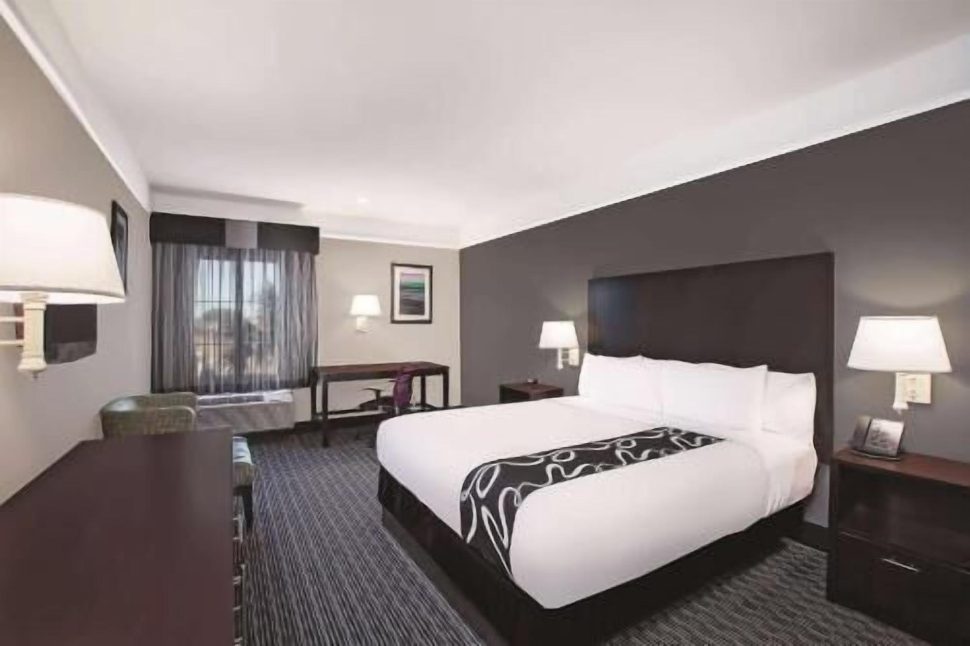 Premium bedding, desk, laptop workspace, blackout drapes