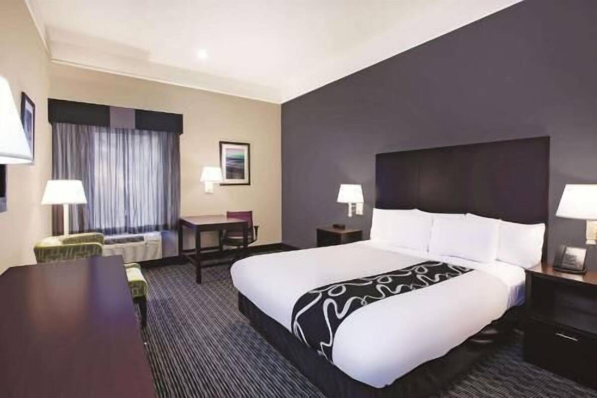Premium bedding, desk, laptop workspace, blackout drapes