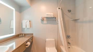 A modern bathroom with a sink, toilet, and bathtub.