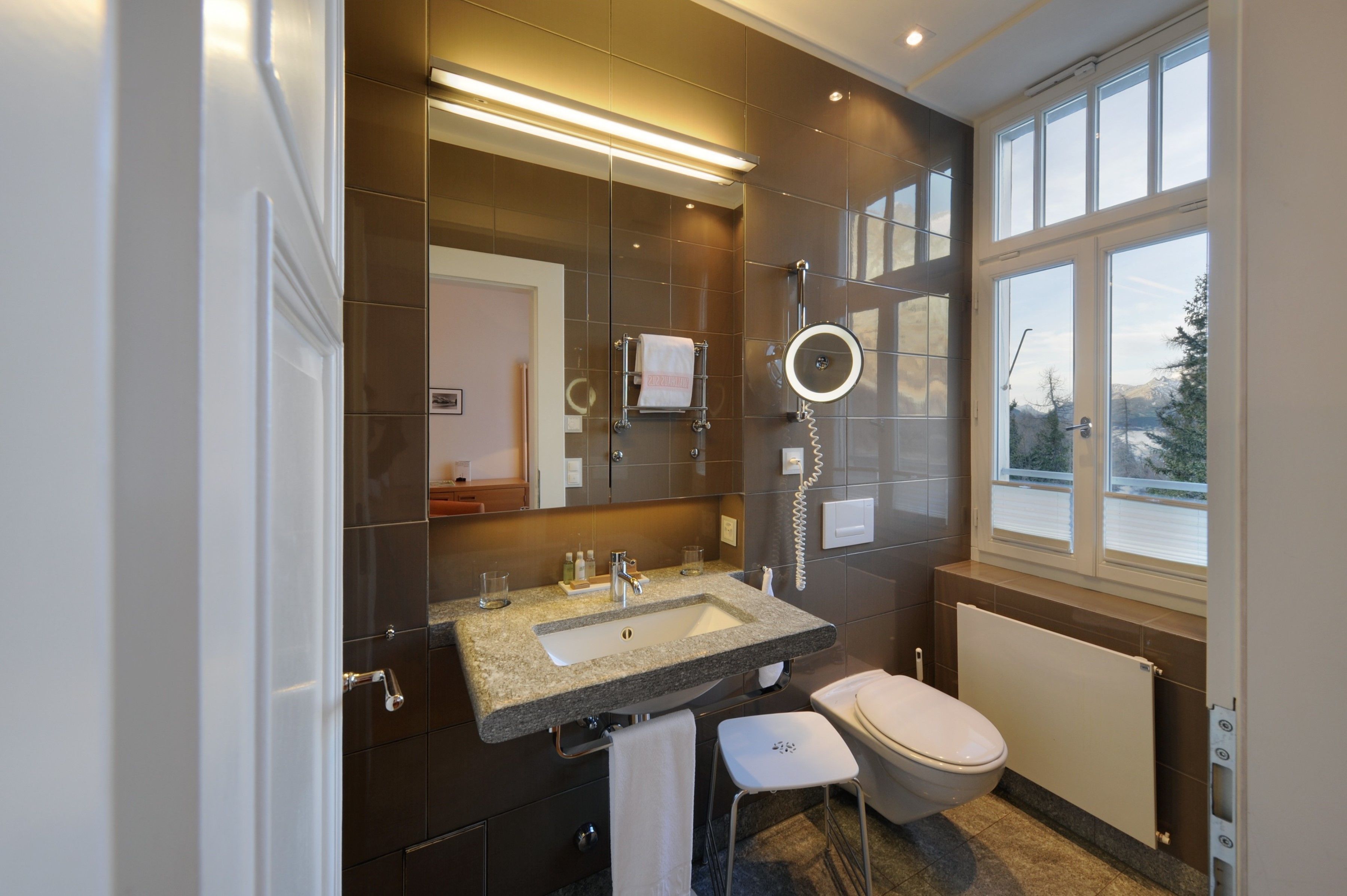 designer toiletries, hair dryer, bathrobes, slippers