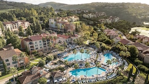 A resort with multiple swimming pools, lush greenery, and residential buildings. - Marriott's Newport Coast Villas (Newport Beach)