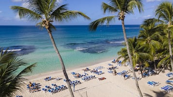 On the beach, white sand, beach towels, beach massages