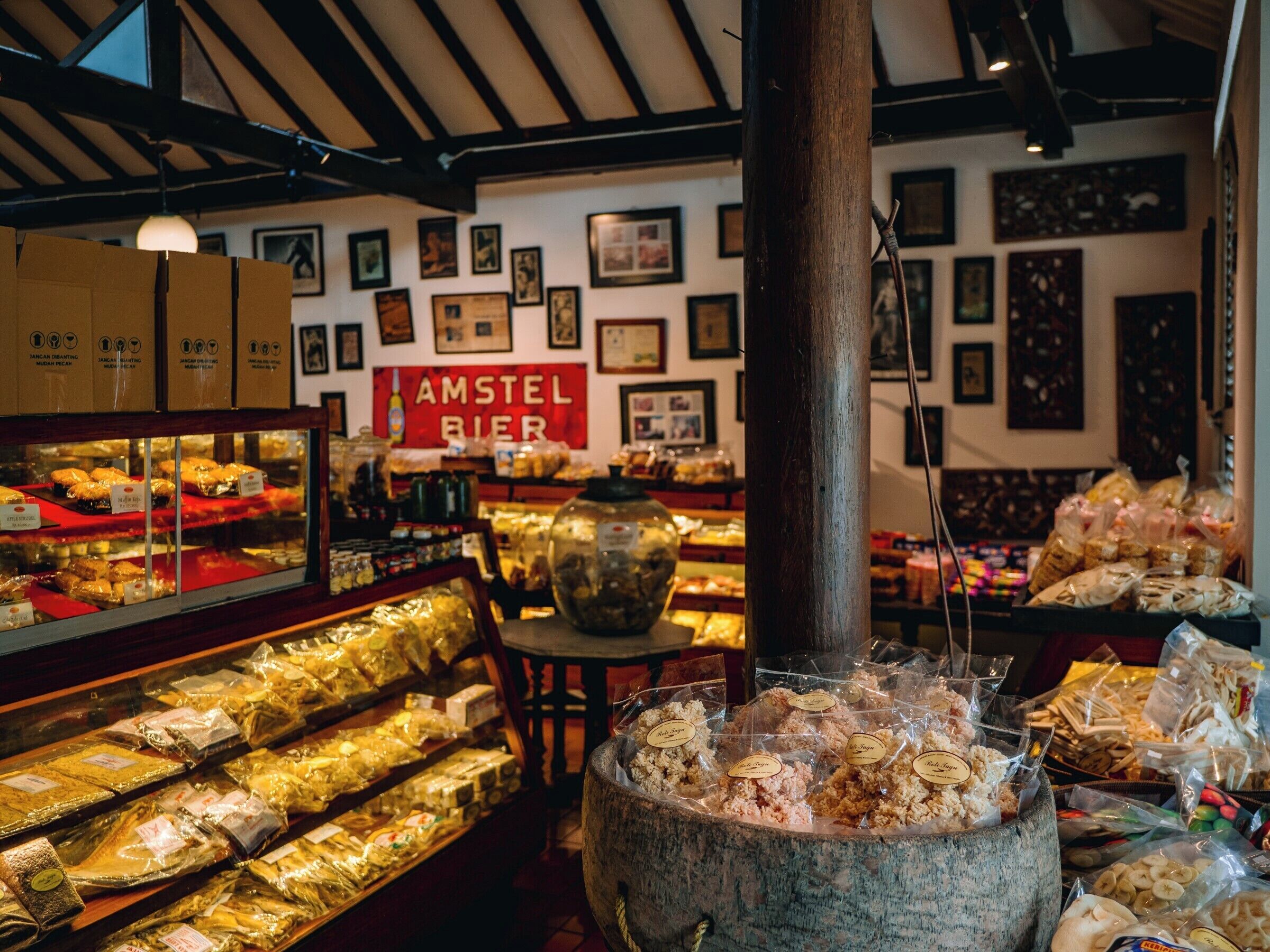 A bakery with various baked goods displayed in glass cases and on shelves.