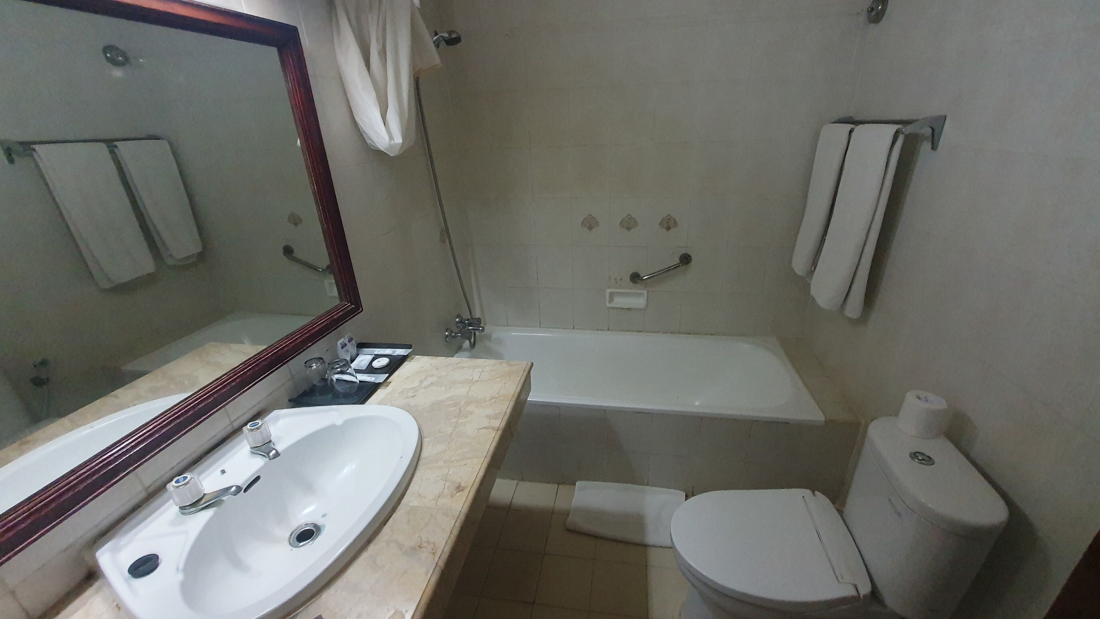 A bathroom with a sink, toilet, and bathtub.