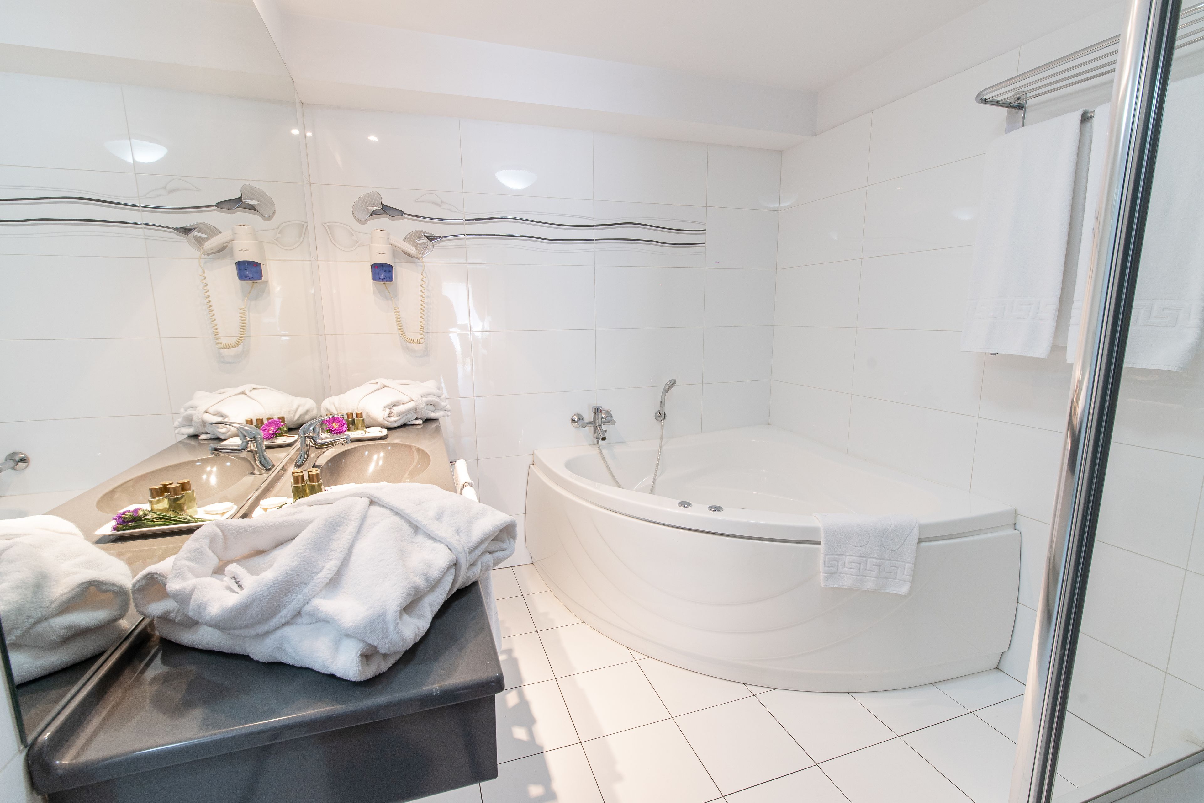 suite, jetted tub | bathroom | combined shower/bathtub, hair dryer, bathrobes, slippers