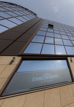 Parliament Hotel features a modern grid-like design with a glass facade.