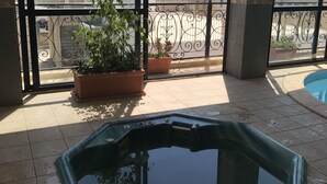 A rooftop pool area with a view of the cityscape, potted plants, and a 'No Diving' sign. - The Windsor Hotel (Sliema)