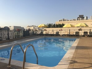 Outdoor pool, open 9:30 AM to 6:30 PM, pool umbrellas, pool loungers