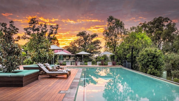 A pool area with lounge chairs, a hot tub, and umbrellas. - Spicers Hidden Vale (Grandchester)