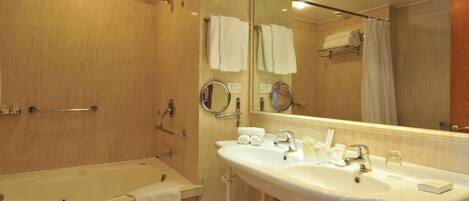 A bathroom with a bathtub, a sink, and a shower.